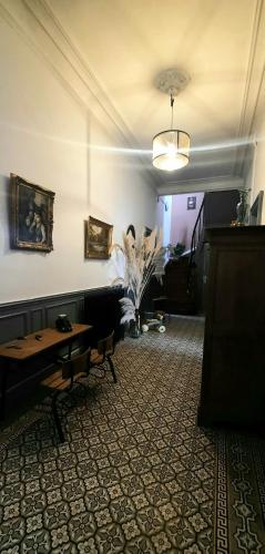 a room with a couch and a table and a plant at La Villa Beausejour in Baives