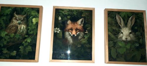 two framed pictures of animals on a wall at La Villa Beausejour in Baives