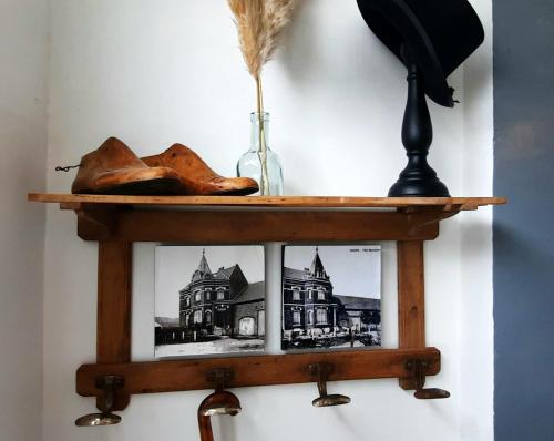 a wooden shelf with a picture of a house at La Villa Beausejour in Baives