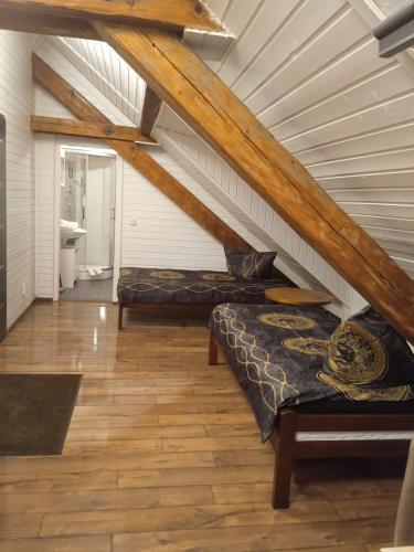 a attic room with two beds and a staircase at Kalinka 90766 Fürth in Fürth