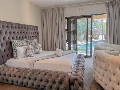 a bedroom with a large bed and a large window at Fullbliss Guesthouse in Johannesburg