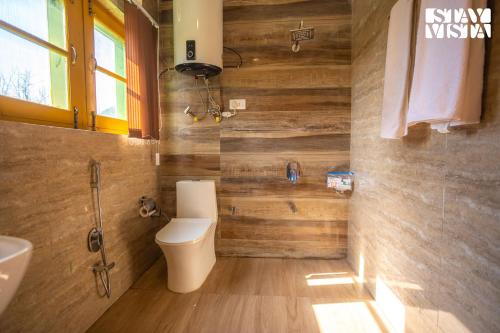 a bathroom with a toilet and a sink at The Dewan Bagh with Heater at Srinagar by StayVista in Srinagar
