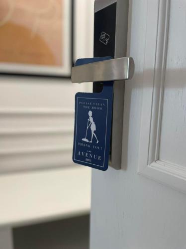 a sign on a door with a person on it at Hotel AVENUE in Ravda