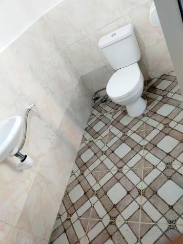 a bathroom with a toilet and a sink at Don Leo's BnB in Esperanza