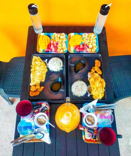 a table with two trays of food on it at Don Leo's BnB in Esperanza