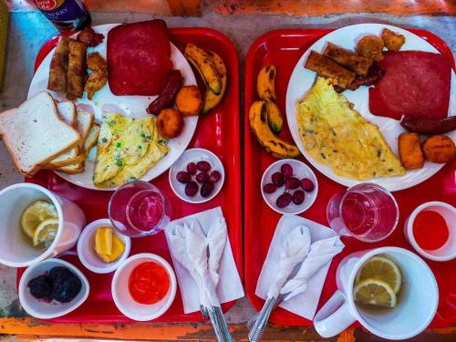 a red tray filled with breakfast food on a table at Don Leo's BnB in Esperanza