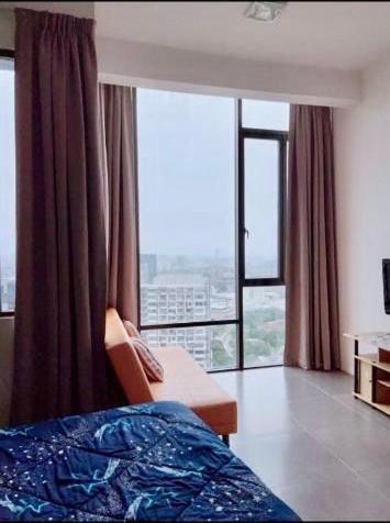 a bedroom with a bed and a large window at Empire damansara in Petaling Jaya