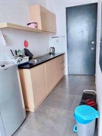 a small kitchen with a sink and a refrigerator at Empire damansara in Petaling Jaya