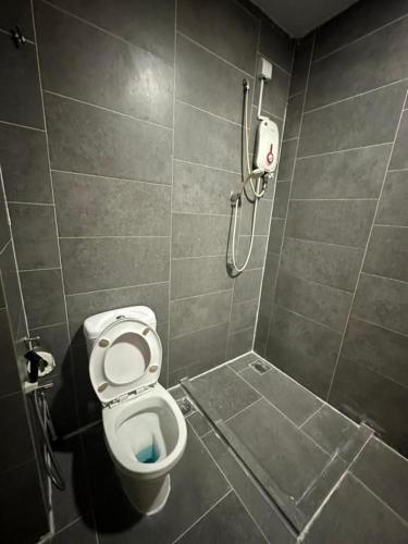 a small bathroom with a toilet and a shower at Empire damansara in Petaling Jaya