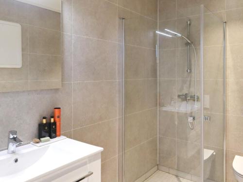 a bathroom with a shower and a sink at 6 person holiday home in Søndeled in Søndeled