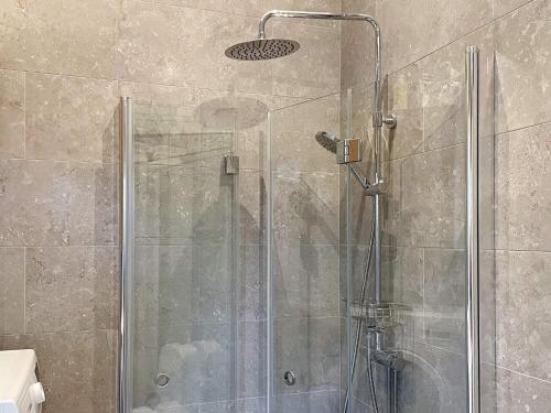 a shower with a glass door in a bathroom at Holiday home VAXHOLM II in Vaxholm