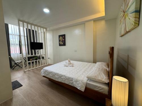 a bedroom with a bed and a tv in it at Florencia's Inn in Panglao