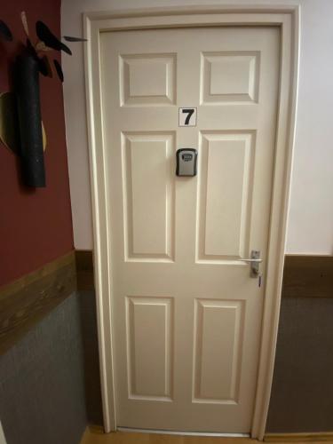 a white door with the number seven on it at Allaga City Center in Budapest