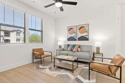 a living room with a couch and two chairs at CozySuites Glendale by the stadium with pool 13 in Glendale