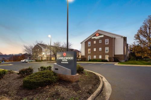 a sign in a parking lot in front of a building at Candlewood Suites St Louis St Charles by IHG in St. Charles