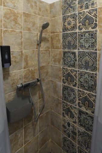 a shower with a shower head in a bathroom at Nice Home Apartment 2 in Abda