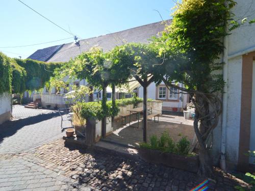 a courtyard with trees and benches and a building at Apartment in Meisberg with In house Catering in Meisburg
