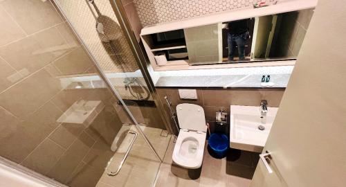 a small bathroom with a toilet and a sink at BBCC APARTMENT AT LUCENTIA 2 in Kuala Lumpur