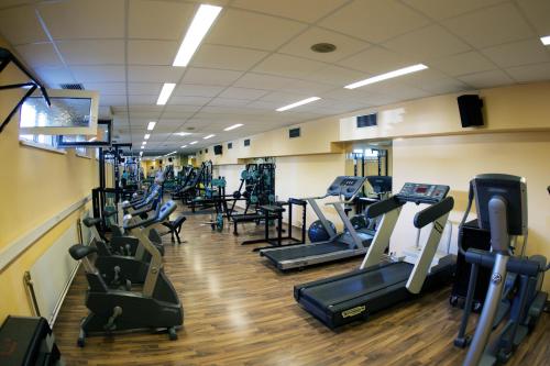 a gym with rows of treadmills and elliptical machines at Tennis- und Freizeitzentrum Neudörfl in Neudörfl