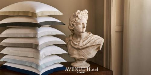 a statue of a bust next to a stack of pillows at Hotel AVENUE in Ravda
