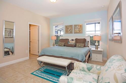 1 dormitorio con 1 cama y 1 sofá en Solterra Resort 5 Bedroom Vacation Home with Pool 1604, en Davenport