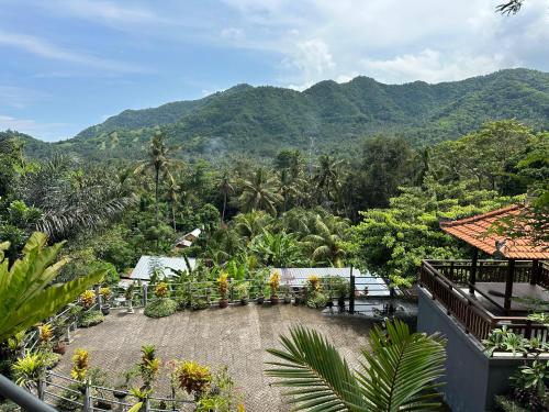 a view of a garden with mountains in the background at Bukit Kembang Sari in Bugbug