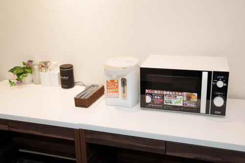 a microwave sitting on top of a counter at Osaka City Hotel Kyobashi in Osaka