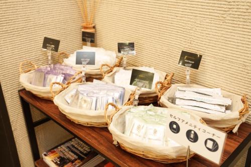 a table with baskets on top of a shelf at Osaka City Hotel Kyobashi in Osaka