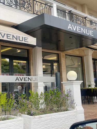an entrance to a store with a sign that reads avenue at Hotel AVENUE in Ravda