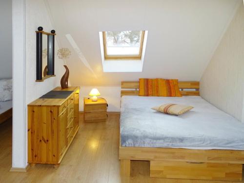 a bedroom with a bed and a dresser and a window at DZ 11 Doppelzimmer in Heringsdorf