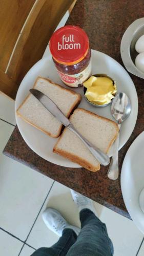 a plate of toast and butter and a plate of food at Valley Plaza Hotel Coorg in Madikeri