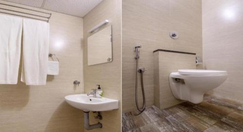 y baño con aseo blanco y lavamanos. en Valley Plaza Hotel Coorg en Madikeri