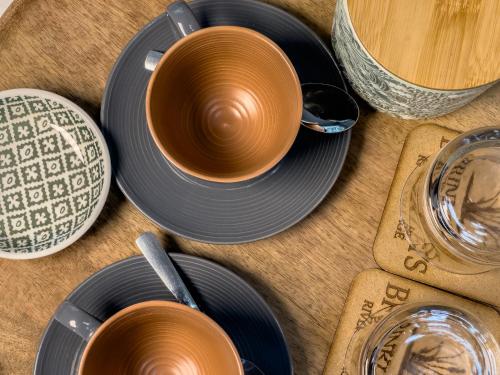 a group of cups and plates on a table at Brinkley's River Village in Klein Brak Rivier