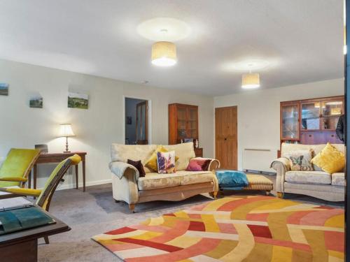 a living room with two couches and a table at Miterdale A Wonderful Home in the Idyllic Duddon Valley in Broughton in Furness