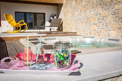 - un plateau avec deux bocaux en maçon et des bougies sur une table dans l'établissement Studio Baïgura - Déconnexion au Pays basque, à Hasparren