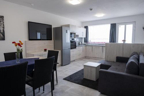 a kitchen and living room with a couch and a table at Penzion Fann in Humpolec