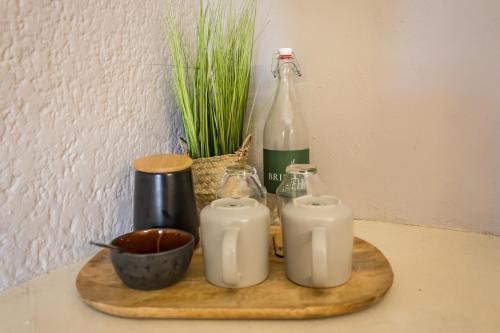 a tray with two candles and a bottle of milk at Brinkley's River Village in Klein Brak Rivier