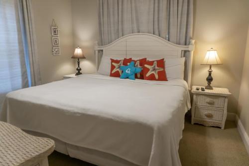 a bedroom with a white bed with stars on it at Beach Front Destin Condo Daily Beach Service - Blue Dolphin in Fort Walton Beach
