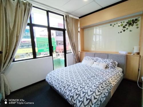 a bedroom with a bed and a large window at Hideaway ~ Best Memories start here! in Mersing