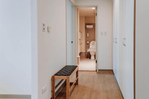 a bathroom with a bench in the middle of a room at LAR Suite in Taichung