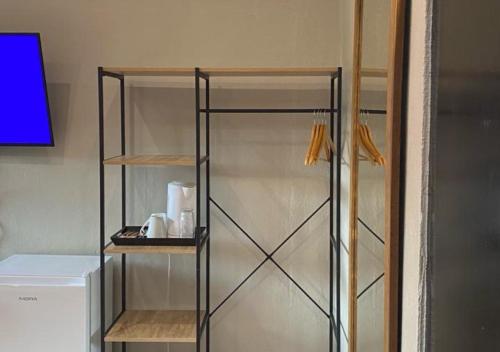 a glass shelf in a kitchen next to a refrigerator at Bothabelo Bed and Breakfast in Phalaborwa