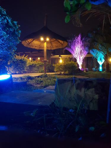 a night view of a building with a umbrella at Villas Rocher - Standard Suite 3A in Grand Baie