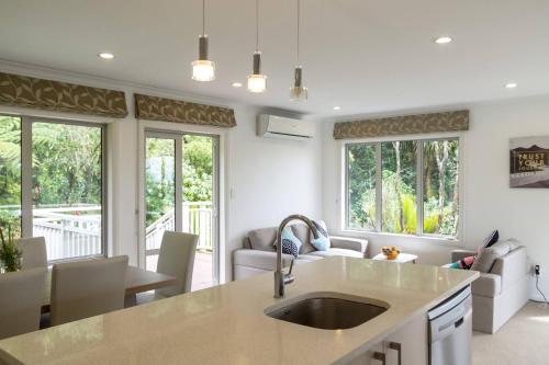 a kitchen with a sink and a living room at memory in Auckland