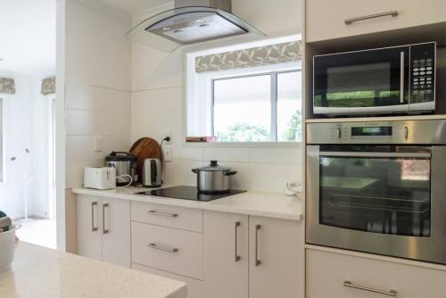 a kitchen with a stove top oven and a microwave at memory in Auckland