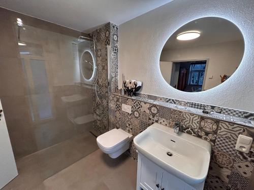 a bathroom with a sink and a mirror at Ferienwohnung Kuckucksnest in Bad Wildbad
