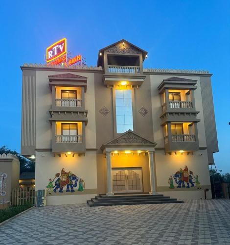 a large building with a sign in front of it at Rajwadu The Village in Jamnagar