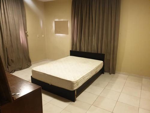 ein kleines Schlafzimmer mit einem Bett in einem Zimmer in der Unterkunft Apartment for rent in Dammam