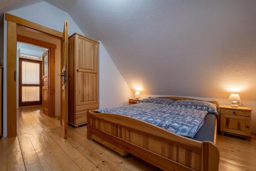 a bedroom with a bed and an open door at Drevenička Vodníček in Liptovský Trnovec