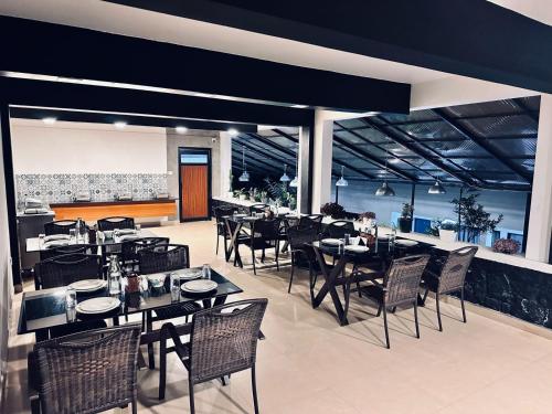 a dining room with tables and chairs in a restaurant at SKY VIEW RESORTS in Munnar