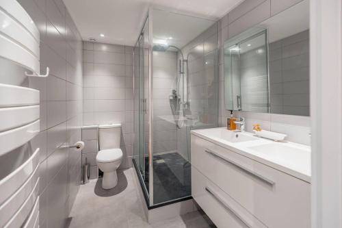 une salle de bain avec toilettes, lavabo et douche dans l'établissement Les Serres, bel appartement avec vue sur le phare, à Le Touquet-Paris-Plage